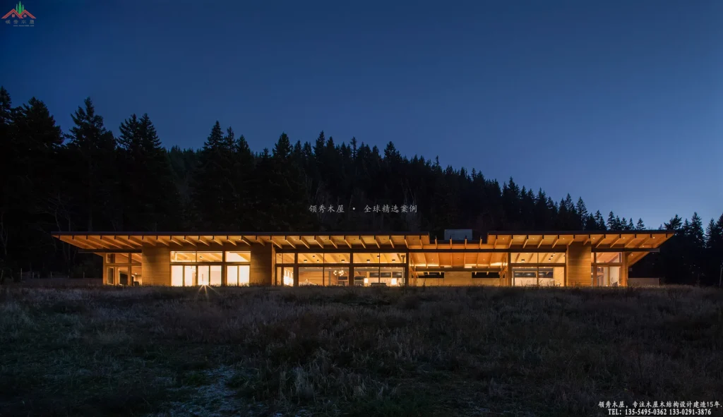 现代胶合木木屋在森林夜景下的建筑外观全景